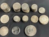 a bunch of coins sitting on top of a table next to each other