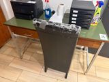 a desk with a printer, printer and printer paper on it
