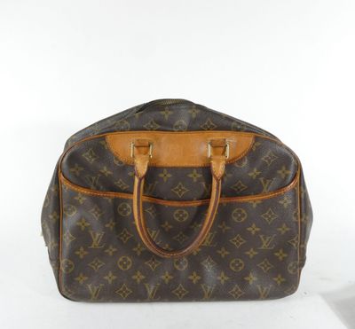 a close up of a louis vuitton handbag on a white surface
