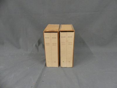 two books are stacked on top of each other on a gray surface