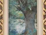 framed watercolor painting of a tree by a river in a gold frame