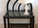 a lamp that is sitting on a table next to a chair