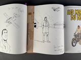 a book with a drawing of a man on a motorcycle