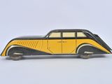 a yellow and black toy car sitting on a white surface