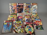 many comic books are stacked on top of each other on a table
