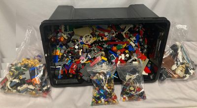un tas de Lego dans une boîte en plastique posée sur une table