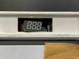 a clock that is on top of a white shelf