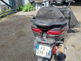 a motorcycle that is parked in front of a garage