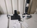 a black and white vacuum on a table next to other items