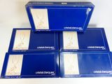 four boxes of dental drugs sitting on top of a white table