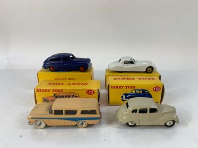 three toy cars are sitting on top of each other on a white surface