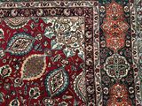 a red and blue rug with a floral design on it