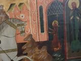 a painting of a man riding a horse in front of a building