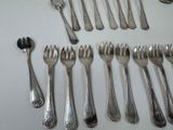 a lot of forks and spoons that are on the table