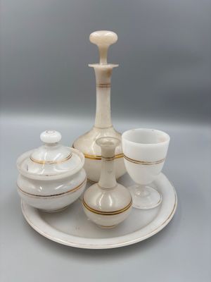 a white and gold tea set on a white plate