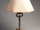 an image of a lamp with a key on it on a table