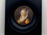 an old picture of a woman in a yellow dress with a veil on her head