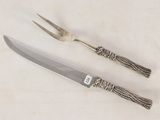 a knife and a fork sitting next to each other on a table