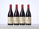 three bottles of red wine sitting on top of a table
