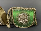 a green and gold clutch bag with a matching bracelet