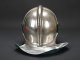 a silver helmet with a green leaf on it