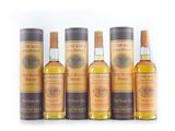 a group of six bottles of whisky sitting next to each other