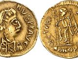 a gold coin with an image of a man on it