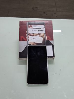 an image of a cell phone sitting on top of a table next to a book