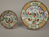 two chinese porcelain plates with flowers and birds on them