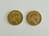 two gold sovereigns, one of which has a head of a man and the other of a woman
