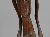 wooden statue of a woman carrying a bowl on her head