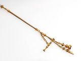 an image of a gold sword with a chain attached to it