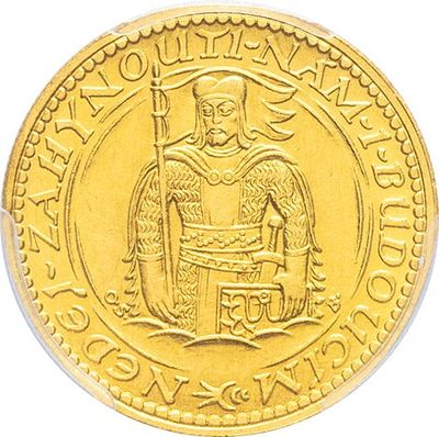 a close up of a gold coin with an image of a man holding a sword