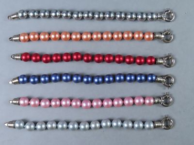 un gros plan sur une rangée de perles de différentes couleurs posées sur une table