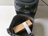 an image of a small air fryer with a box in it