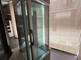 a glass display case in the middle of a room