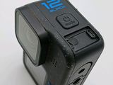 an action camera that is sitting on a white surface