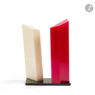 two pieces of red and white soap on a black stand