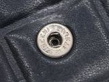 a close up of a button on a black leather jacket