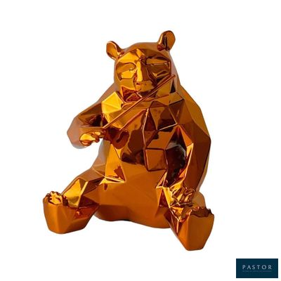 une statue d'ours en or brillant, assise sur ses pattes arrière