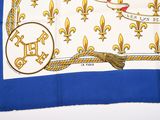 an image of a blue and white table cloth with gold fleur de lis on it