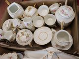 a box full of tea and coffee cups and saucers