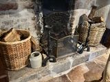 a fire place with a basket of logs and a basket of logs next to it