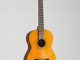 a close up of an orange guitar on a white background