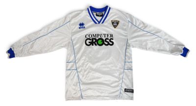 the shirt is white and blue with a green logo on it