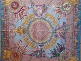 a colorful tapestry hanging on a wall in a room
