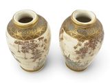 two vases sitting side by side on a white surface