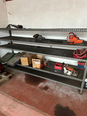 a shelf that has tools on it in a garage