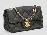 un sac Chanel noir matelassé, avec des finitions dorées et une chaîne