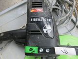 a black and green electric sander sitting on a table